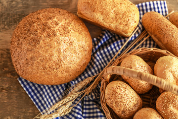 Canvas Print - Beautiful composition with wicker basket and delicious bread on wooden table