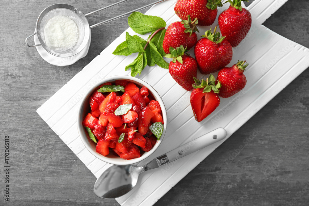 Composition with delicious sliced strawberry on grey table