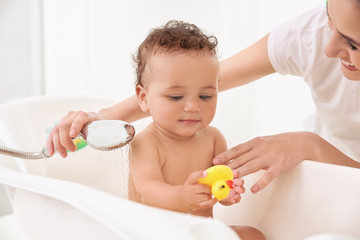 Canvas Print - Mother bathing baby at home