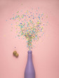 Splashing hard / Creative concept photo of champagne bottle with confetti on pink background.