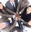 © ASDF - business team standing with hands clasped together