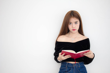 Portrait of thai adult beautiful girl reading red book