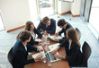 © ty - Business meeting in an office, the businesspeople are discussing a document.