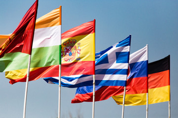 flags of different countries against the blue sky