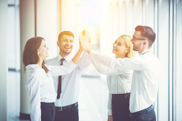 The happy business people greeting on the sun background