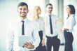 © realstock1 - The happy businessman hold tablet near the colleagues