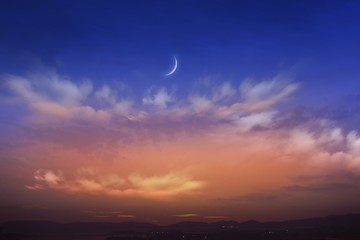 Wall Mural - Sunset and new moon . Paradise heaven  . Against the background of clouds . beautiful sky .  peaceful sky for the Muslim . Against the background of clouds .