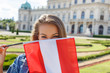 Young woman holding austrian flag in Vienna