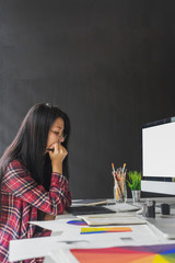 Fototapete - Female graphic designer working on computer while using graphic tablet at desk in the office