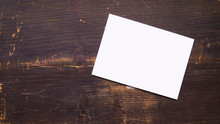 A White Blank Postcard Template For Graphic Design On A Wooden Background