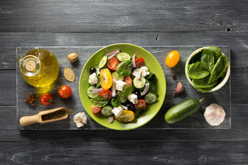 Poster - fresh greek salad in plate and ingredients