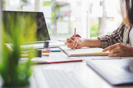 Graphic designer using digital tablet and computer in the office