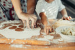 Little boy with mom in the kitchen preparing dough