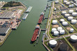 Tankers moored at an oil terminal with storage silo's in the Port of Rotterdam.
