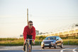 © Anatoliy Karlyuk - Outdoor shot of stylish confident young male employee or student commuting to work or college riding fixed gear bike on highway early in the morning. People, modern lifestyle and transportation