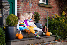 Kids At House Porch On Autumn Day