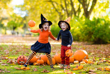 Kids With Pumpkins In Halloween Costumes