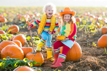 kids picking pumpkins on halloween pumpkin patch