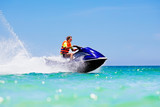 Teenager on water scooter. Teen age boy water skiing.