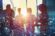 © alphaspirit - Silhouette of businessperson in office with network effect. concept of partnership and teamwork