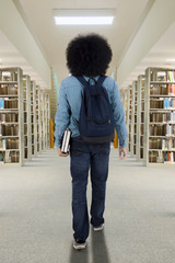 Wall Mural - Afro student walking into the library