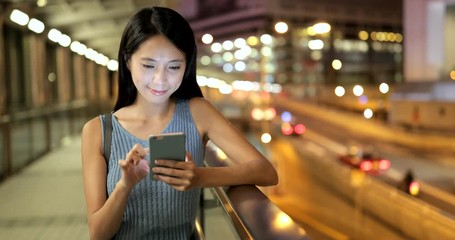 Wall Mural - Woman use of mobile phone in the city at night