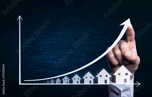 Fotomural Business hand touching on a real estate graph.