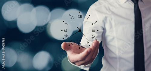 Cuadros en Lienzo Businessman holding clock. Business time management .