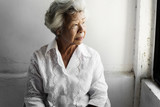 Fototapeta  - Side view of elderly asian woman with thoughtful face expression