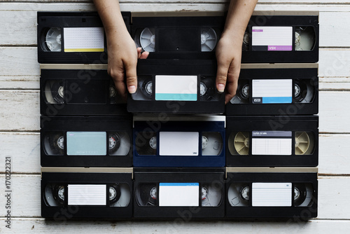 Fotografía Hands holding selecting a videotape