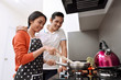 © Leo Lintang - Portrait of asian couple smiling and cooking together