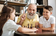 © zinkevych - Smiling grandfather having idea about next chess move