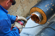 Electric Wheel Grinding On Steel Pipe 
Metal Worker Grinding Metal Of Pipeline