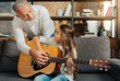 © zinkevych - Loving grandfather teaching his granddaughter how to play guitar