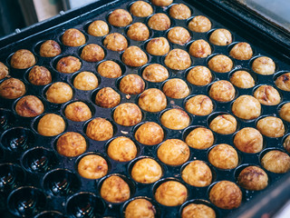 Cooking Takoyaki on hot pan Famous food Osaka Japan