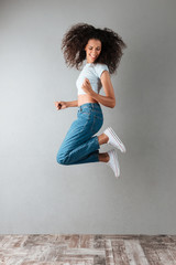 Wall Mural - Funny casual woman jumping isolated