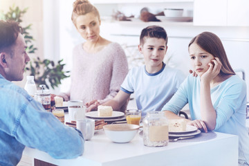 Canvas Print - Upset young lady getting emotional during family breakfast