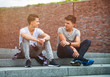 © leszekglasner - Two friends casual wear sitting on stairs in town and talking, best friend