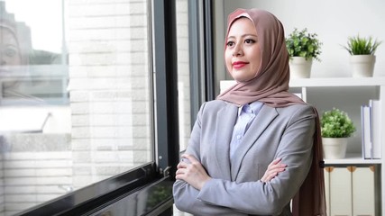 Wall Mural - muslim businesswoman standing by window