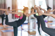 © Somkiat - Group Young woman doing yoga and stretching exercises in the Studio.