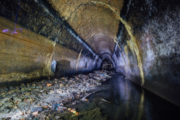 Sticker - Flooded by wastewater sewage collector. Dirty sewer tunnel under city