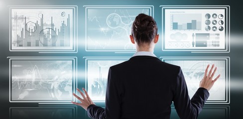Poster - Composite image of rear view of businesswoman using digital