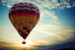 Colorful hot air balloon flying on sky at sunset. travel and air transportation concept - vintage and retro filter effect style
