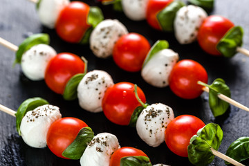 Italian food - caprese salad with tomato, mozzarella and basil, mediterranean diet and weight loss concept