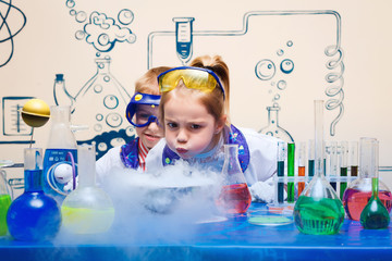 small children do chemical experiments. cheerful science,