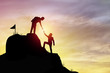 © khwanchai - silhouette people helping hand to climb mountain rock, concept as winner, improvement and goal to success in business and sport