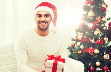 Wall Mural - happy man with christmas gift box at home