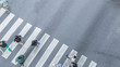 From the top view of people walk on street pedestrian crossroad in the city street with the motorcycle drives pass road ,bird eye view.