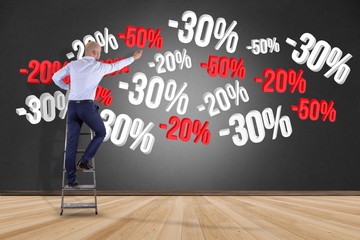 Poster - businessman in front of a wall with sales promotion 20% 30% and 50% flying on an interface - shoppin