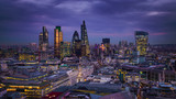 Fototapeta Londyn - London, England - Panoramic skyline view of Bank district of London with the skyscrapers of Canary Wharf at the background at blue hour